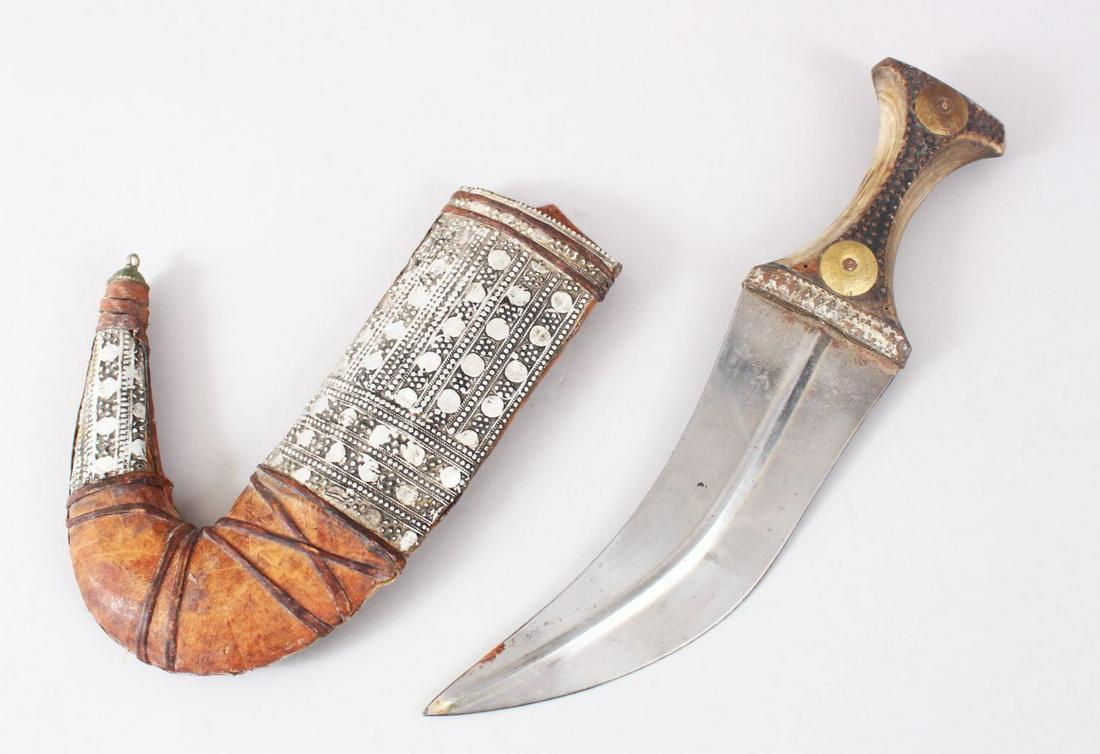 A GOOD PERSIAN JAMBYA DAGGER, with a wooden handle &: A GOOD PERSIAN JAMBYA DAGGER, with a wooden handle & white metal mounted sheath, 32cm long,