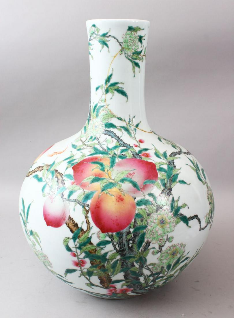 A LARGE CHINESE FAMILLE ROSE PEACH DECORATION PORCELAIN: A LARGE CHINESE FAMILLE ROSE PEACH DECORATION PORCELAIN BOTTLE VASE, the body with decoration of bats, fruits and foliage, the base with a six character qianlong mark, 51.5cm high.