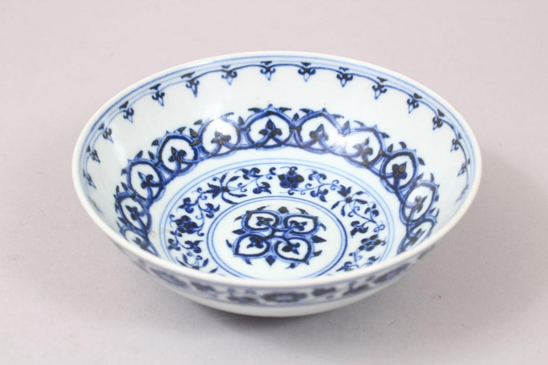 A GOOD CHINESE MING STYLE BLUE & WHITE PORCELAIN BOWL,: A GOOD CHINESE MING STYLE BLUE & WHITE PORCELAIN BOWL, decorated with formal borders an foliage, the base bearing a six character mark, 13.5cm diameter.