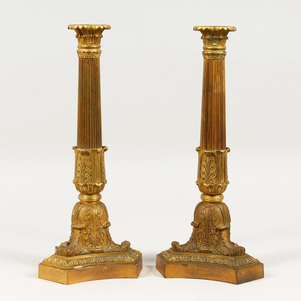 A GOOD PAIR OF LOUIS XVITH ORMOLU CANDLESTICKS on: A GOOD PAIR OF LOUIS XVITH ORMOLU CANDLESTICKS on triangular bases. 13ins high.
