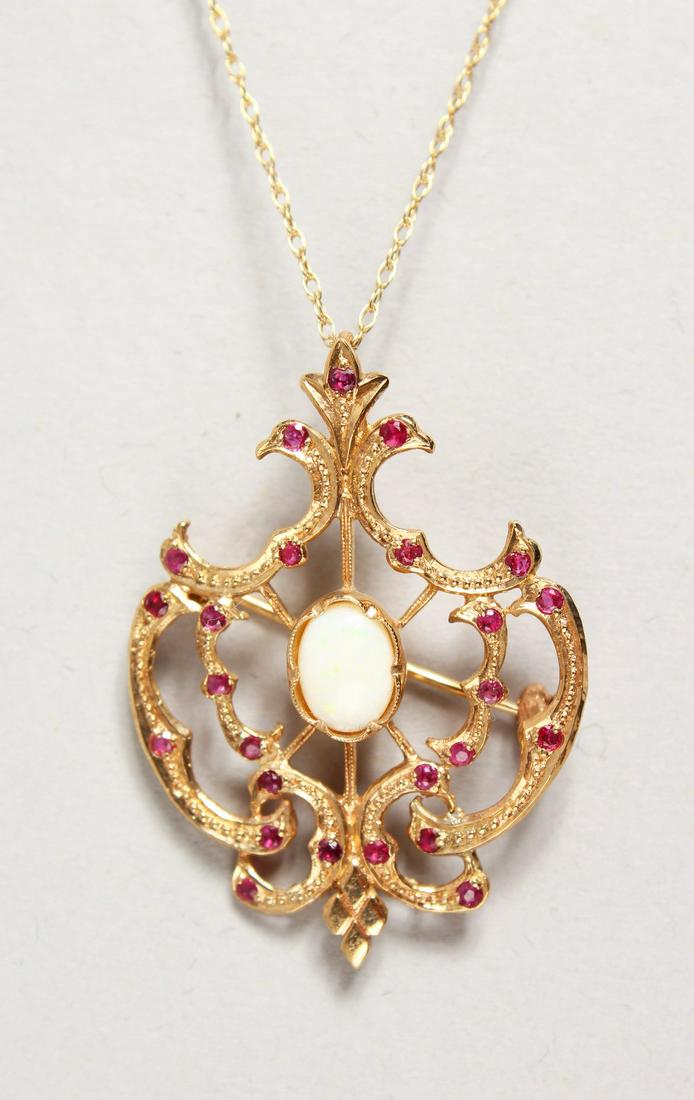 A 9CT GOLD OPAL AND RUBY PENDANT BROOCH on a chain.: A 9CT GOLD OPAL AND RUBY PENDANT BROOCH on a chain.
