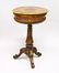 A VICTORIAN FIGURED WALNUT OVAL TEAPOY, fitted with two