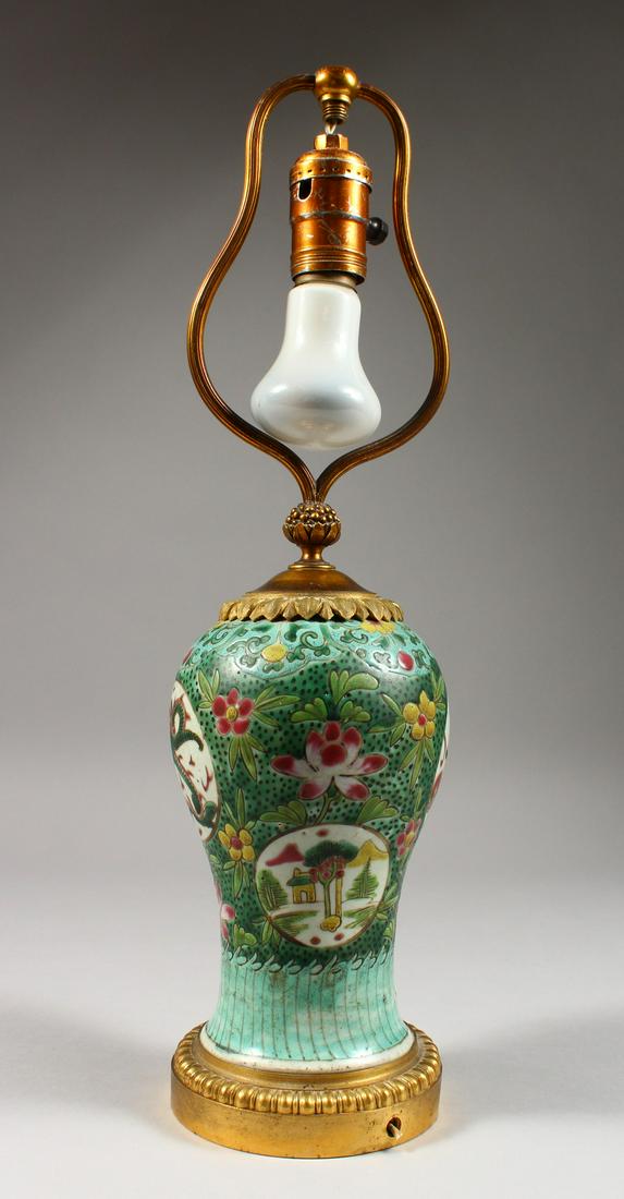 A CHINESE FAMILLE VERTE BALUSTER SHAPED VASE, with: A CHINESE FAMILLE VERTE BALUSTER SHAPED VASE, with ormolu mounts, as a lamp. 17ins high.