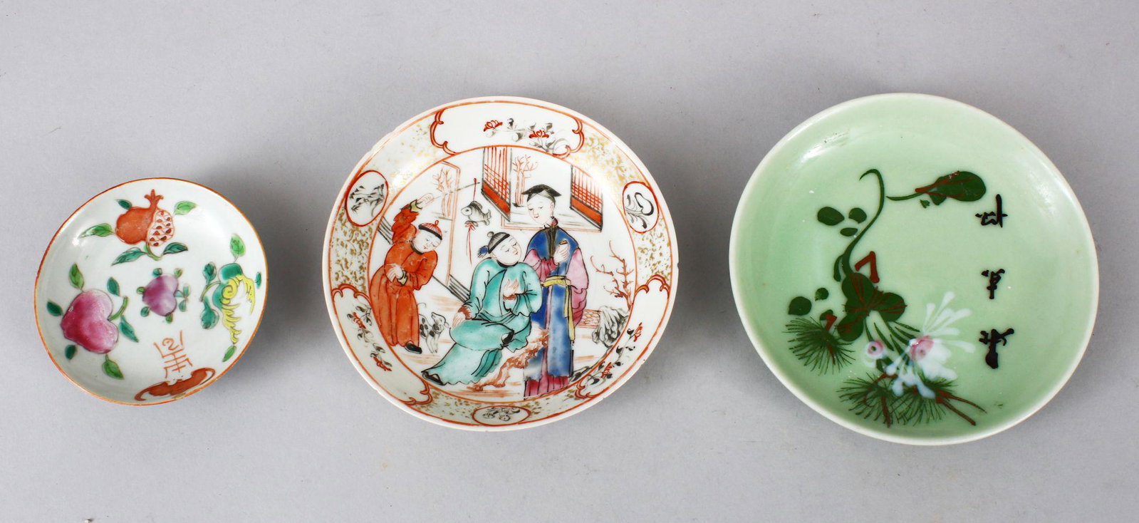 THREE 18TH / 19TH CENTURY CHINESE PORCELAIN SAUCERS,: THREE 18TH / 19TH CENTURY CHINESE PORCELAIN SAUCERS, one small famille rose saucer with fruit and symbol decoration,base with four character mark, 8cm, one famille rose mandarin saucer, 12cm, and a ce