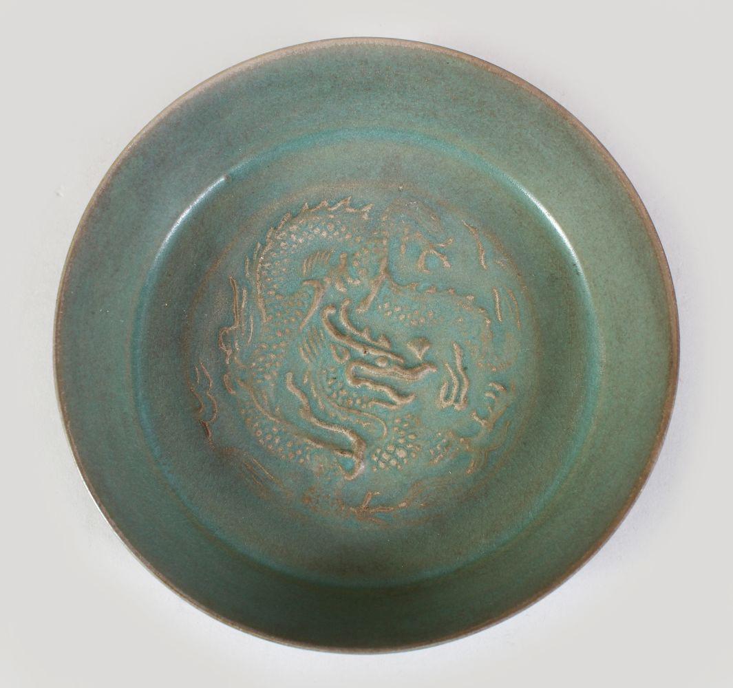 A CHINESE CELADON RU WARE DRAGON DISH, the interior (1 of 3)