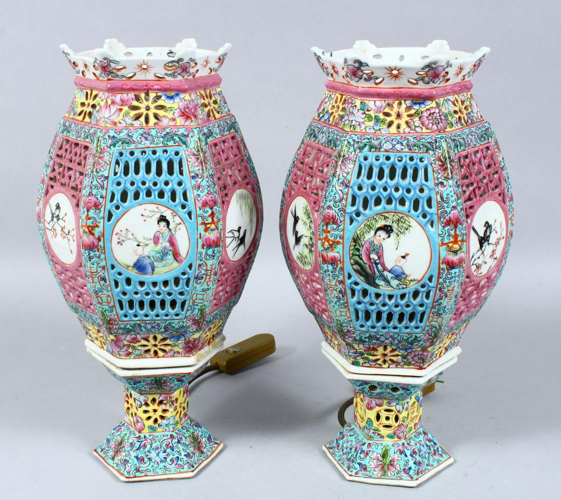 A PAIR OF 19TH / 20TH CENTURY CHINESE FAMILLE ROSE: A PAIR OF 19TH / 20TH CENTURY CHINESE FAMILLE ROSE PORCELAIN HEXAGONAL LAMPS, the body pierced and decorated with roundel panels of figures and birds amongst flora, further decorated with bats, and na