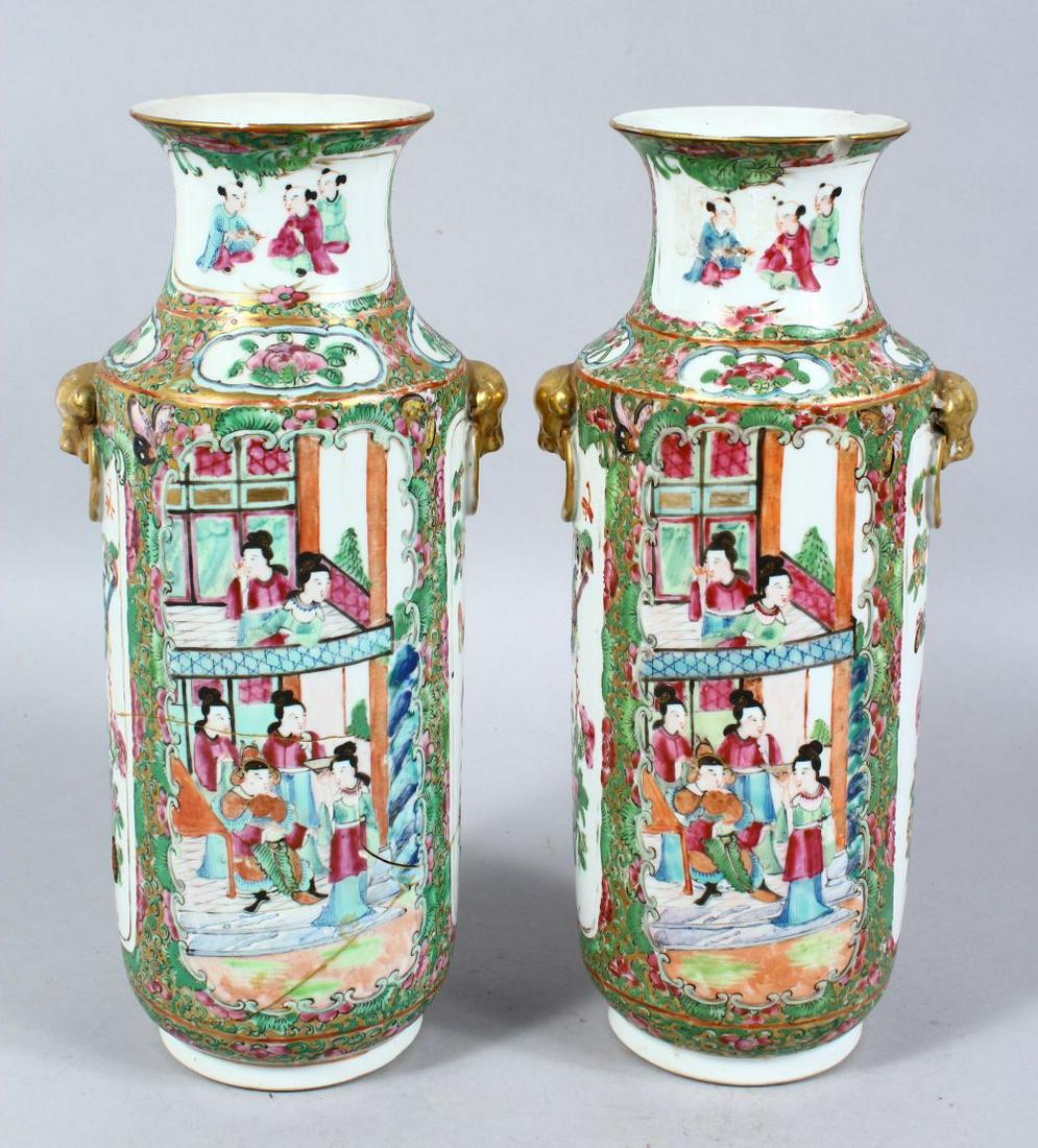 A PAIR OF 19TH CENTURY CHINESE CANTON FAMILLE ROSE: A PAIR OF 19TH CENTURY CHINESE CANTON FAMILLE ROSE PORCELAIN VASES, the vases decorated with panels of figures interior and birds amongst foliage, further decorated with gilt highlights around butterl
