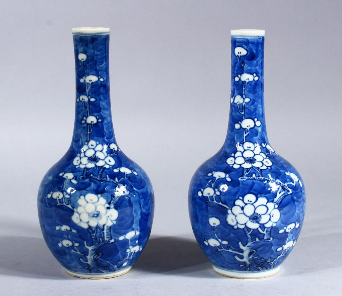 A PAIR OF 19TH CENTURY CHINESE BLUE & WHITE PORCELAIN: A PAIR OF 19TH CENTURY CHINESE BLUE & WHITE PORCELAIN PRUNUS VASES, decorated with prunus pattern, the bases with double blue rings, 19.5cm high.