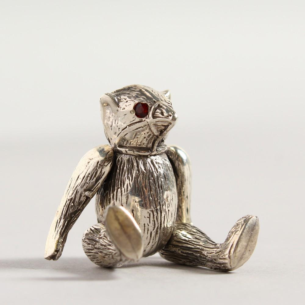 A NOVELTY SILVER TEDDY BEAR PIN CUSHION: A NOVELTY SILVER TEDDY BEAR PIN CUSHION