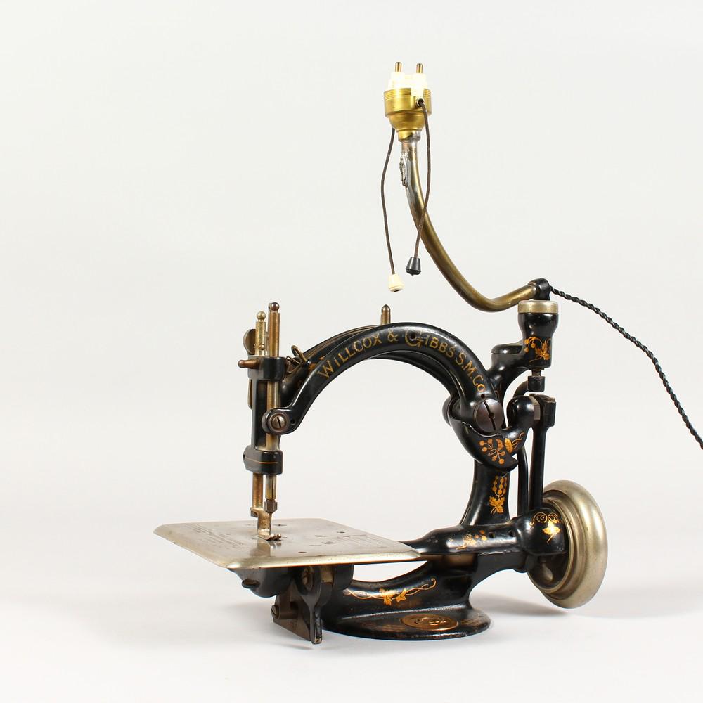 AN EARLY CAST IRON SEWING MACHINE by WILLCOX & GIBBS,: AN EARLY CAST IRON SEWING MACHINE by WILLCOX & GIBBS, New York, London & Paris.