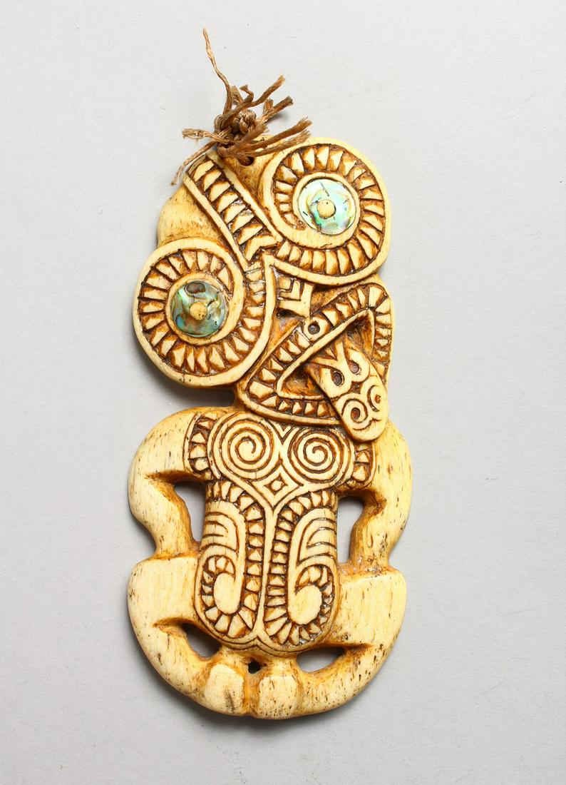 A MAORI CARVED WHALEBONE TIKI with abalone eyes.: A MAORI CARVED WHALEBONE TIKI with abalone eyes. 4.5ins high.