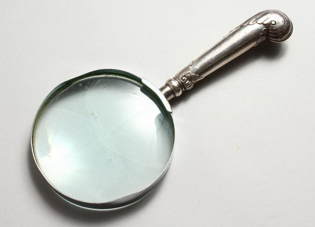 A MAGNIFYING GLASS, with silver pistol handle.: A MAGNIFYING GLASS, with silver pistol handle.