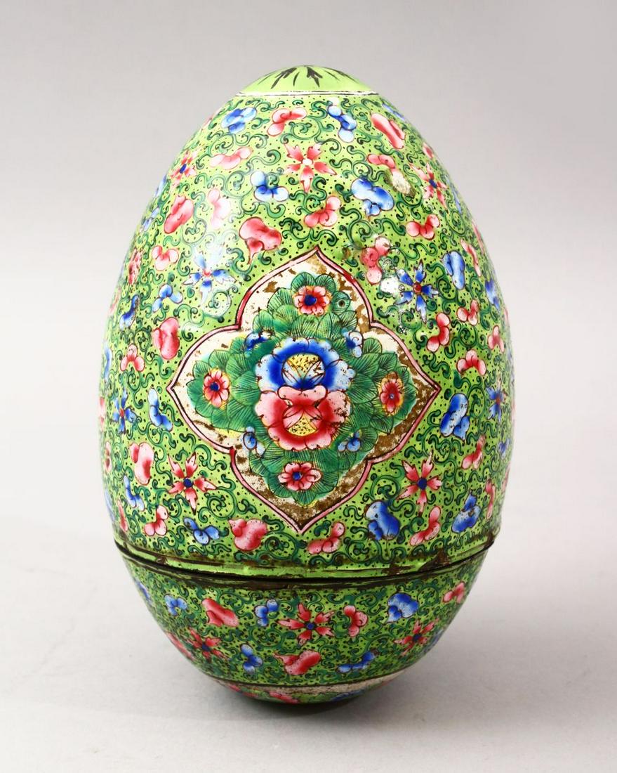 A GOOD 19TH CENTURY CHINESE CANTON ENAMEL EGG, the egg: A GOOD 19TH CENTURY CHINESE CANTON ENAMEL EGG, the egg with a green ground with floral panel decoration, further decorated with scenes of scrolling vine and rosette decoration, 15cm.