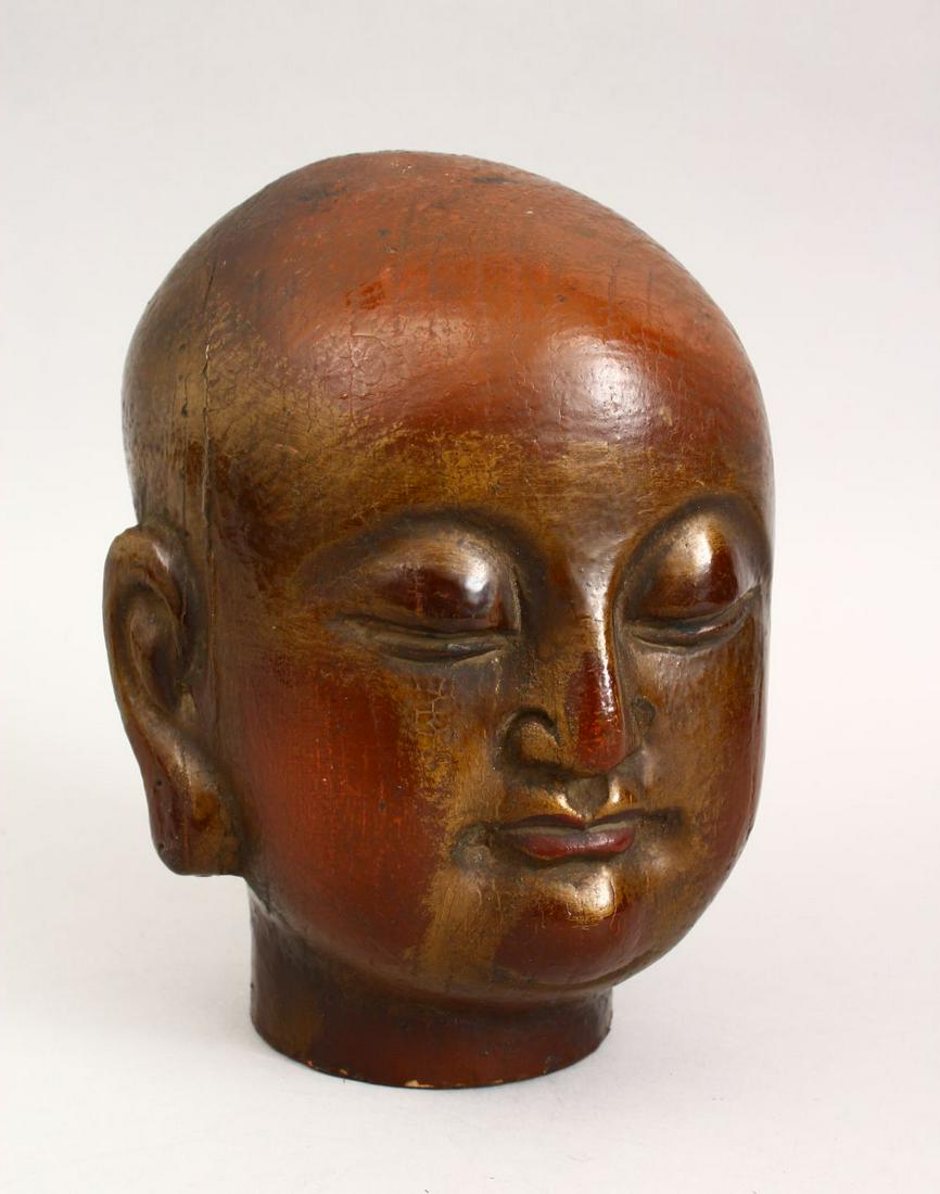 A GOOD CHINESE CARVED WOOD & LACQUER HEAD OF BUDDHA,: A GOOD CHINESE CARVED WOOD & LACQUER HEAD OF BUDDHA, With traces of gilding, 22cm high.