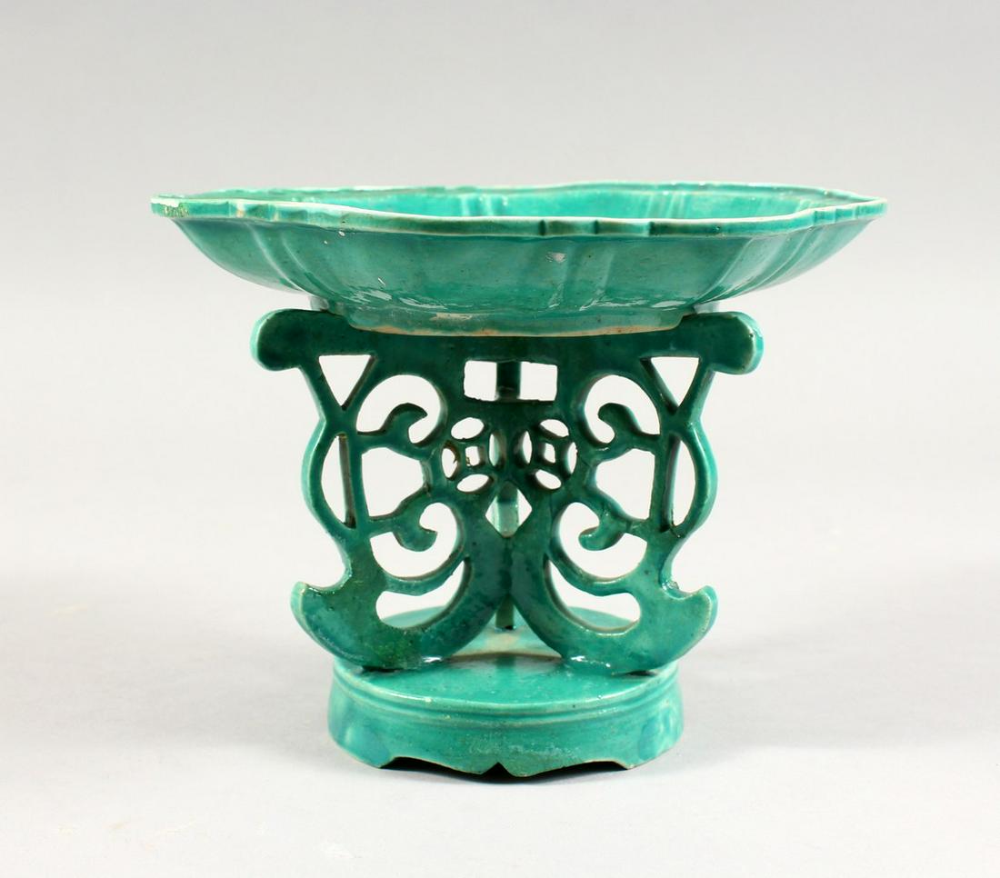 A GOOD 19TH CENTURY CHINESE TURQUOISE ENAMELLED BISCUIT: A GOOD 19TH CENTURY CHINESE TURQUOISE ENAMELLED BISCUIT PORCELAIN MOULDED DISH AND STAND, the stand with carved scroll work decoration supported upon a circular base, jiaqing / daoguang period, the ba