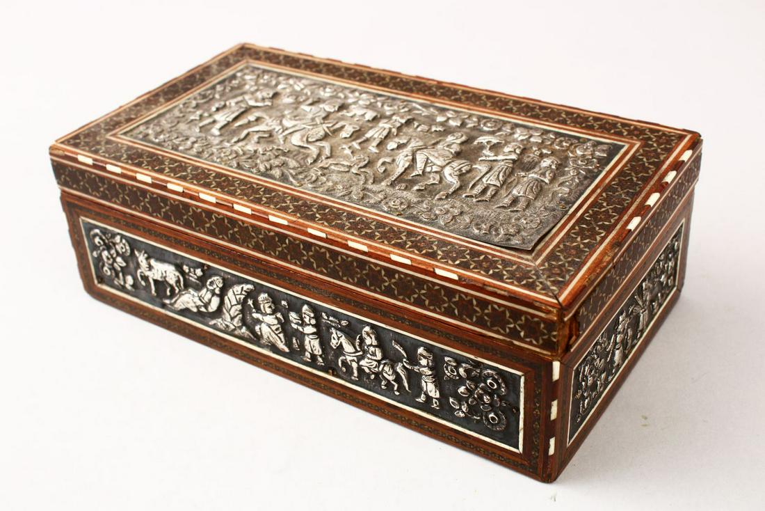 A GOOD IRANIAN SHIRAZ KHATEMI WOODEN & WHITE METAL BOX,: A GOOD IRANIAN SHIRAZ KHATEMI WOODEN & WHITE METAL BOX, the bod with inset white metal embossed panels depicting figures upon horseback in landscapes, with inlaid border design, 21.5cm wide x 12cm dee