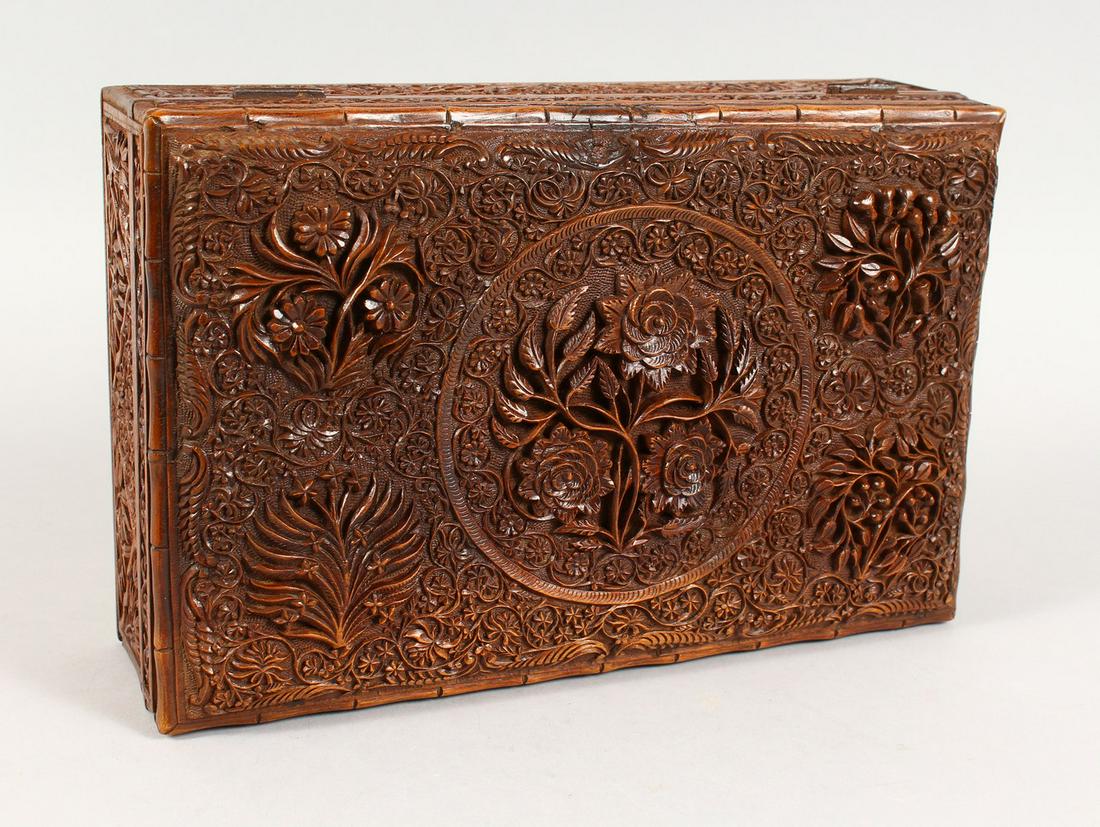 A GOOD 19TH CENTURY INDIAN CARVED WOOD LIDDED BOX, with: A GOOD 19TH CENTURY INDIAN CARVED WOOD LIDDED BOX, with relief carved floral decoration, 9cm high x 30cm wide x 20cm deep