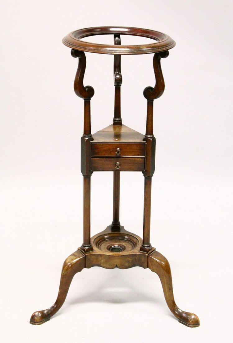 A GEORGE III STYLE MAHOGANY WASHSTAND, with a circular: A GEORGE III STYLE MAHOGANY WASHSTAND, with a circular bowl aperture, two drawers, on three curving legs. 2ft 7ins high.