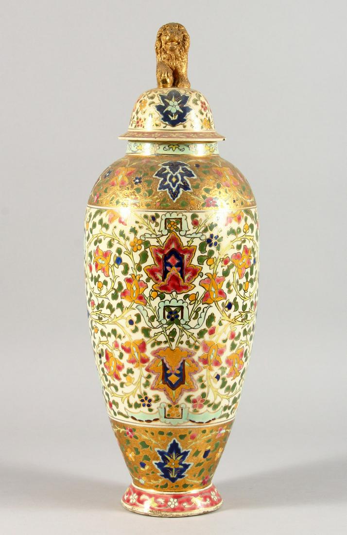 A HUNGARIAN PORCELAIN VASE AND COVER, in the: A HUNGARIAN PORCELAIN VASE AND COVER, in the Oriental/Islamic taste. 17ins high.