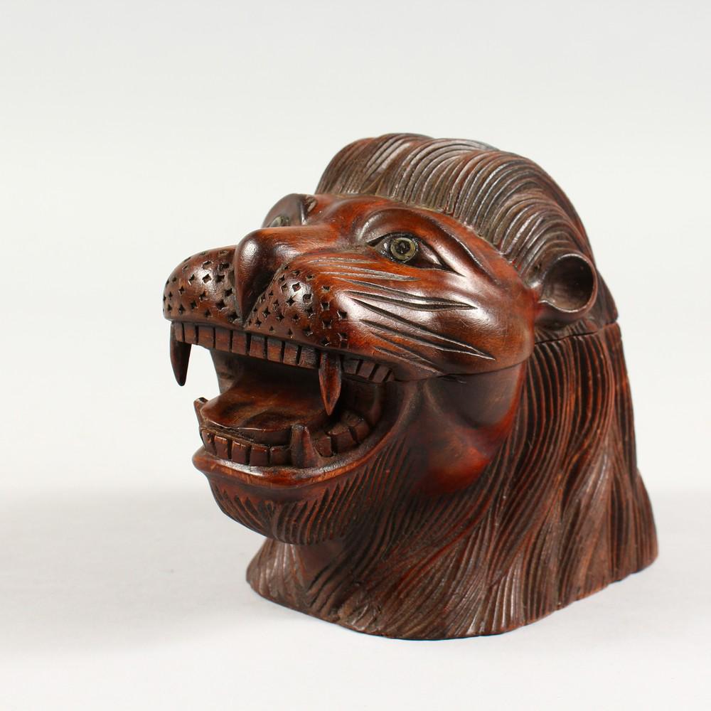 A CARVED WOOD LION'S HEAD TOBACCO JAR, modern. 7ins: A CARVED WOOD LION'S HEAD TOBACCO JAR, modern. 7ins long.