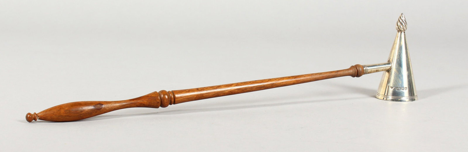 A SILVER CANDLE SNUFFER, with turned wood handle.: A SILVER CANDLE SNUFFER, with turned wood handle. London 1995. 12ins long.