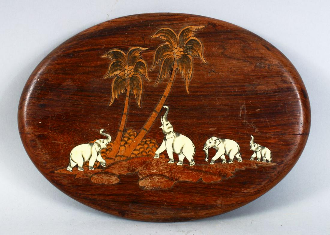 AN INDIAN CARVED WOOD AND INLAID PAN EL OF ELEPHANTS,: AN INDIAN CARVED WOOD AND INLAID PAN EL OF ELEPHANTS, the elephant inlaid with carved bone slithers and exotic woods, 30cm x 21cm