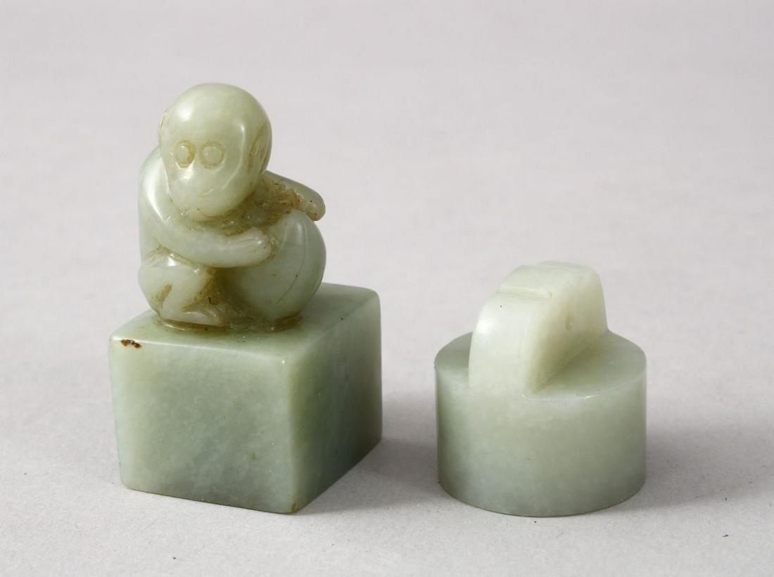 TWO GOOD CHINESE CARVED JADE SEALS, one depicting a: TWO GOOD CHINESE CARVED JADE SEALS, one depicting a monkey crouched amongst his nut, the base carved with characters, 4cm high, also with a smaller circular seal pendant, again carved to the base, 2.5