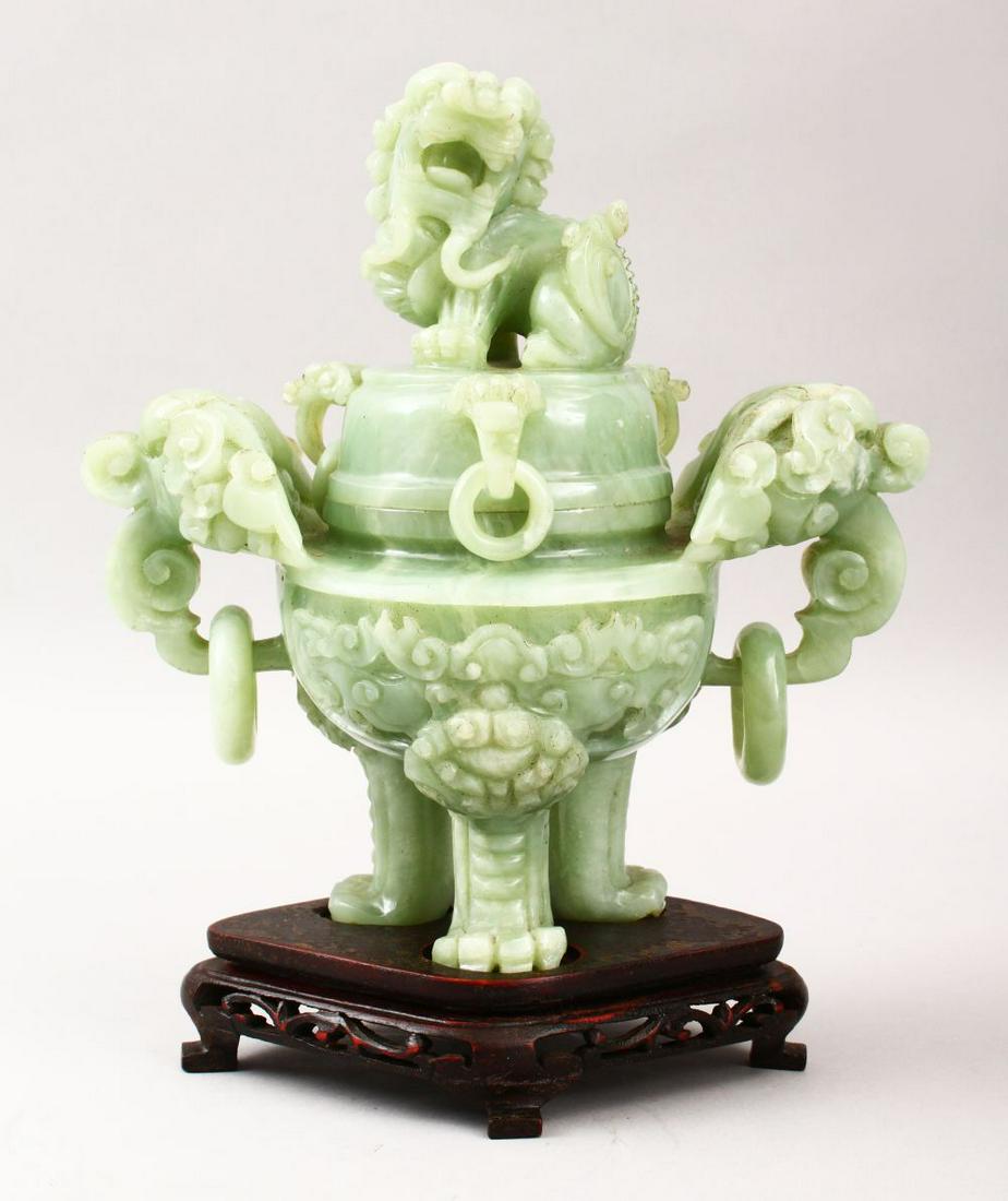 A GOOD CHINESE CARVED JADE TRIPOD CENSER, COVER &: A GOOD CHINESE CARVED JADE TRIPOD CENSER, COVER & STAND, the censer carved with twin lion dog handles with further moulding's and rings, the cover with a lion dog finial, with its original fitted hard