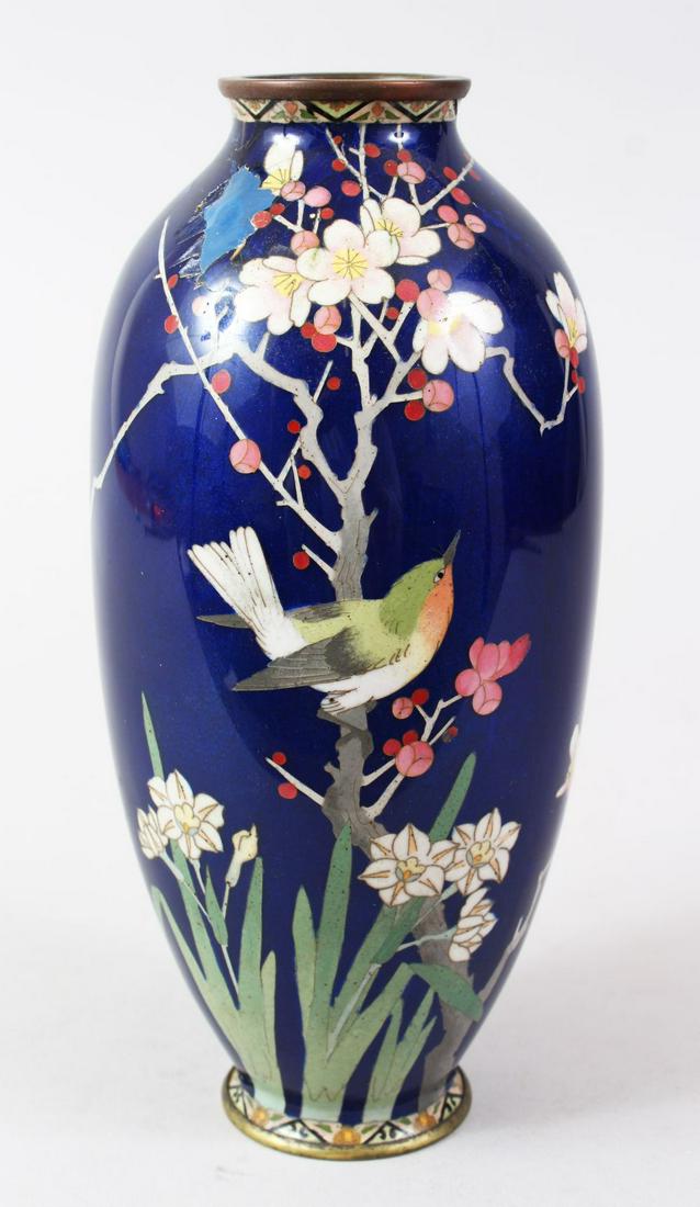 A JAPANESE MEIJI PERIOD CLOISONNE VASE, the rich blue: A JAPANESE MEIJI PERIOD CLOISONNE VASE, the rich blue ground with decoration of a bird amongst trees, 24cm high.