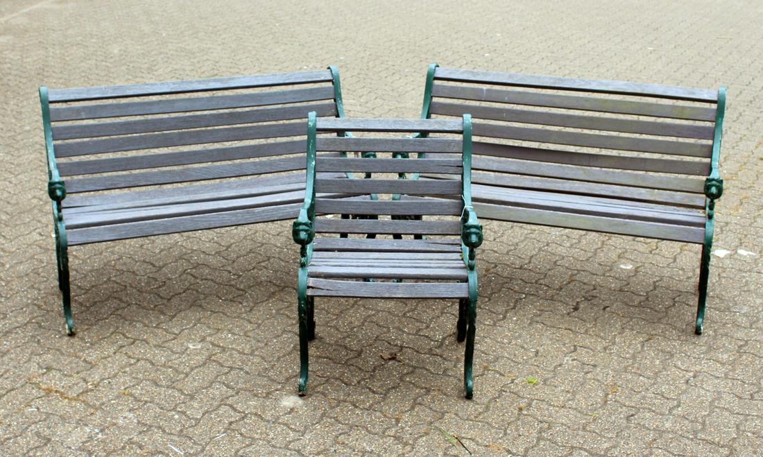 A PAIR OF VICTORIAN STYLE GARDEN BENCHES, each with: A PAIR OF VICTORIAN STYLE GARDEN BENCHES, each with ornate cast metal ends and wooden slats; together with the matching armchair. Benches: 4ft 2ins wide. Chair: 2ft 0ins wide.