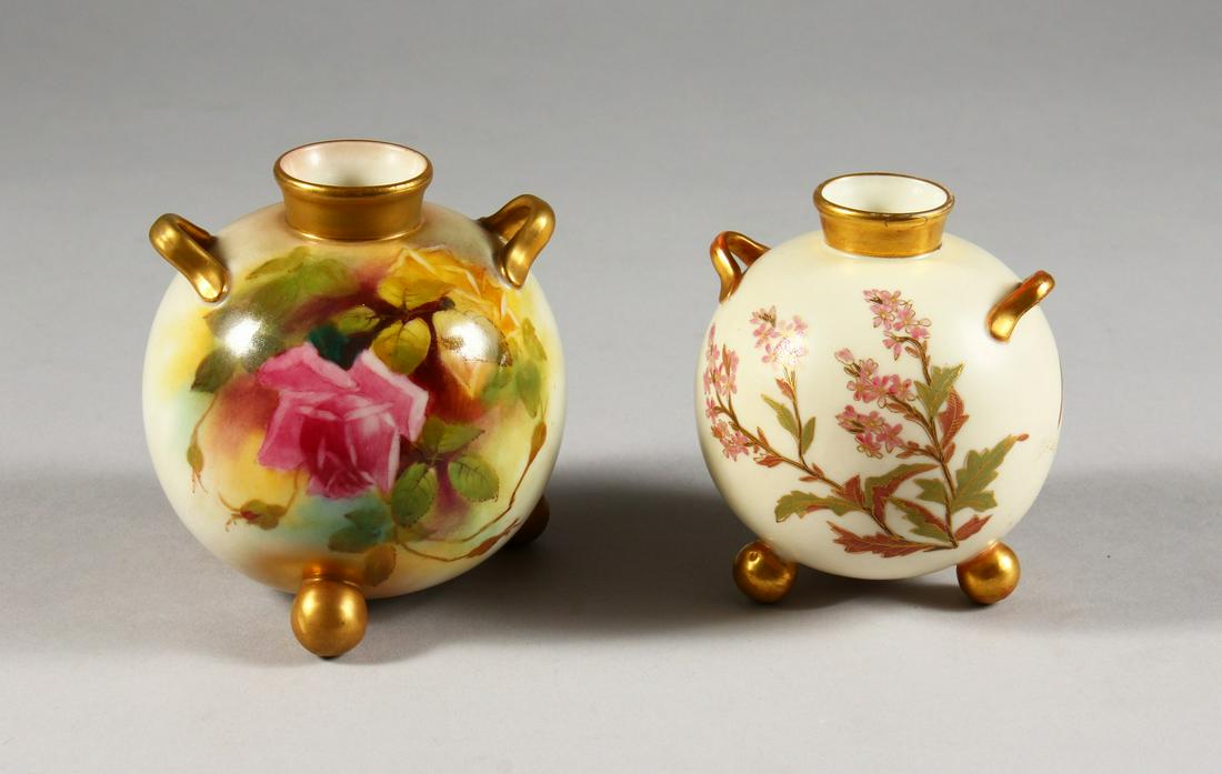 A ROYAL WORCESTER SPHERICAL TWO HANDLED VASE, on three: A ROYAL WORCESTER SPHERICAL TWO HANDLED VASE, on three feet painted with roses C.1912 and a similar smaller ivory ground vase C. 1889.