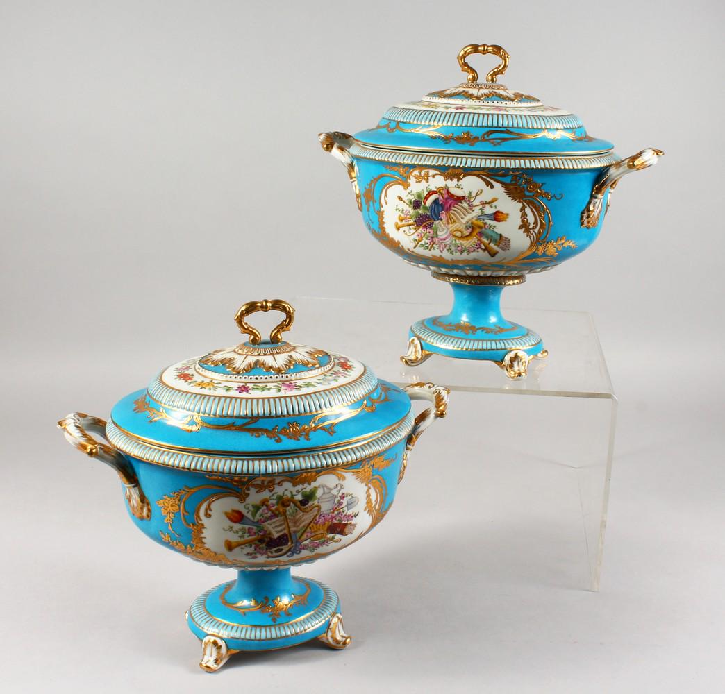 A PAIR OF PORCELAIN TWIN-HANDLED PEDESTAL TUREENS: A PAIR OF PORCELAIN TWIN-HANDLED PEDESTAL TUREENS AND COVERS, pale blue ground decorated with classical motifs. In the style of Sevres.12ins wide.