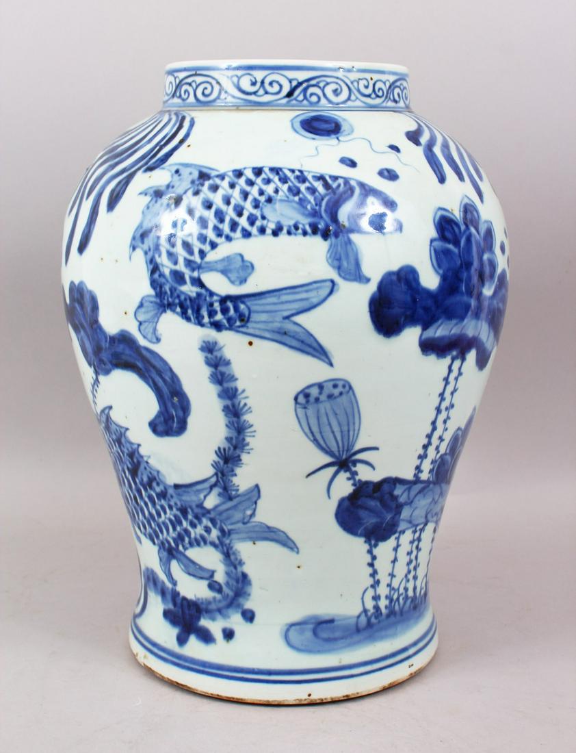 A LARGE CHINESE BLUE & WHITE PORCELAIN KOI CARP FISH: A LARGE CHINESE BLUE & WHITE PORCELAIN KOI CARP FISH VASE, the body decorate with carp fish amongst reed, the base unglazed, 36.5cm high x 27cm wide.