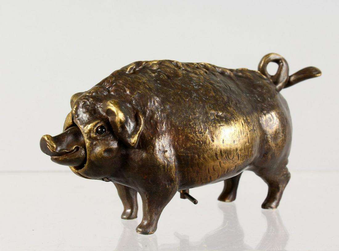 A NOVELTY BRONZE PIG BELL. 6.5ins long.: A NOVELTY BRONZE PIG BELL. 6.5ins long.