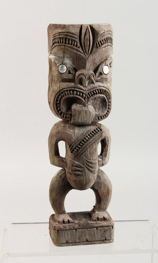 A MAORI TIKI CARVED WOOD FIGURE. 10ins high.: A MAORI TIKI CARVED WOOD FIGURE. 10ins high.