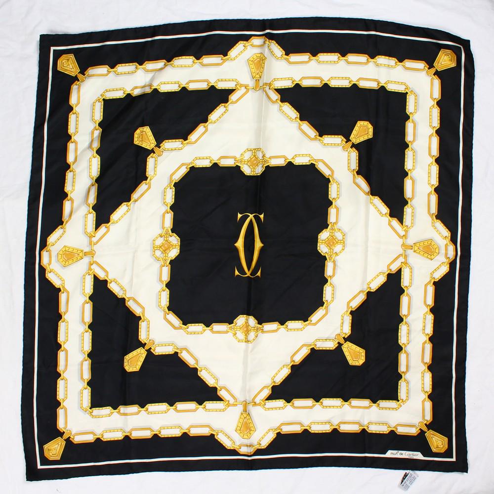 A CARTIER SILK SCARF, with chain decoration, in a: A CARTIER SILK SCARF, with chain decoration, in a Cartier bag.
