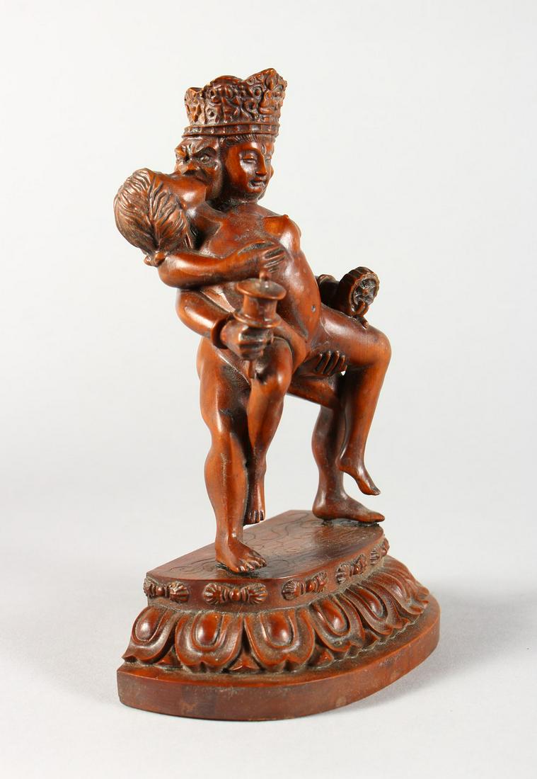 AN EROTIC CARVED WOOD FIGURE GROUP.: AN EROTIC CARVED WOOD FIGURE GROUP.