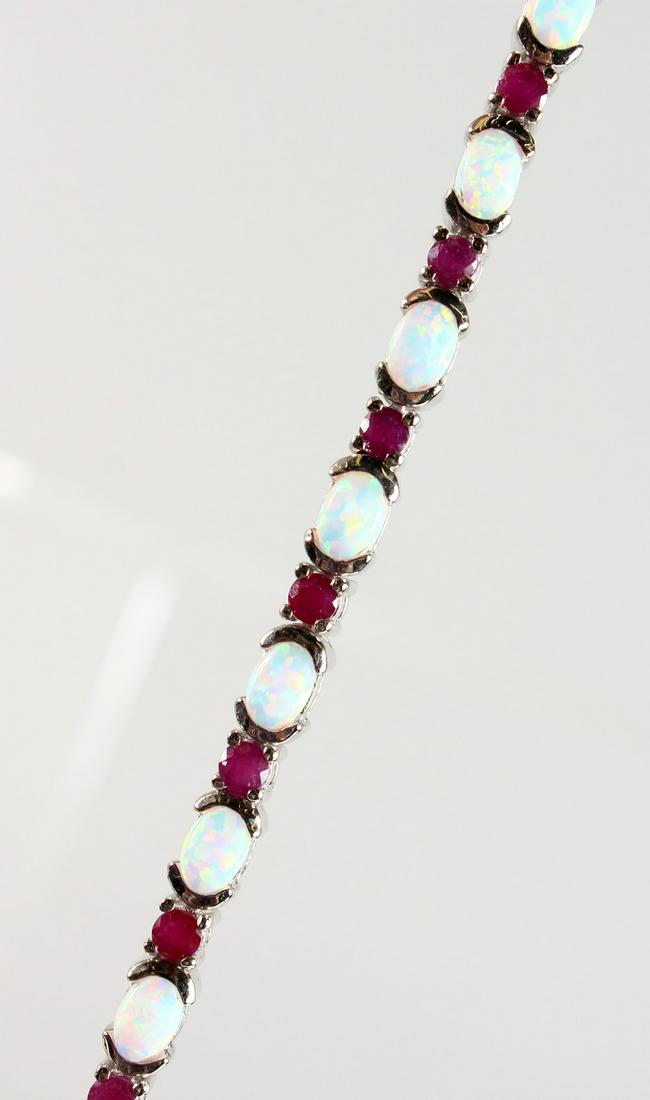 A SILVER, OPAL AND RUBY SET LINE BRACELET.: A SILVER, OPAL AND RUBY SET LINE BRACELET.