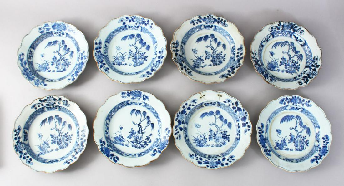 EIGHT 18TH CENTURY CHINESE BLUE & WHITE PORCELAIN: EIGHT 18TH CENTURY CHINESE BLUE & WHITE PORCELAIN PLATES, each dish decorated with floral borders surrounding native landscape views, 22cm. (8)