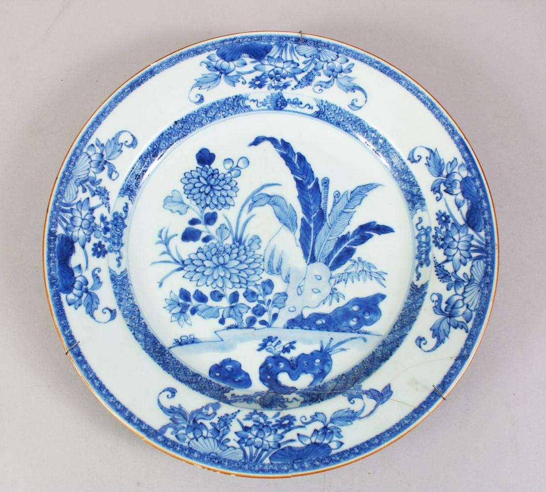 A 19TH CENTURY CHINESE BLUE & WHITE PORCELAIN PLATE,: A 19TH CENTURY CHINESE BLUE & WHITE PORCELAIN PLATE, with native floral decoration, metal hanging bracket, 28cm diameter.