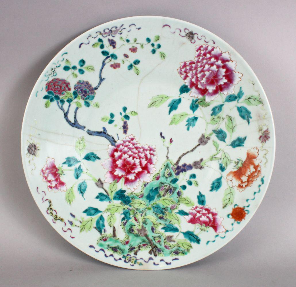 A GOOD AND LARGE 19TH CENTURY CHINESE CELADON FAMILLE: A GOOD AND LARGE 19TH CENTURY CHINESE CELADON FAMILLE ROSE PORCELAIN DISH, decorated with a native display of flora with an outer border with eight Buddhist symbols, 34cm diameter.