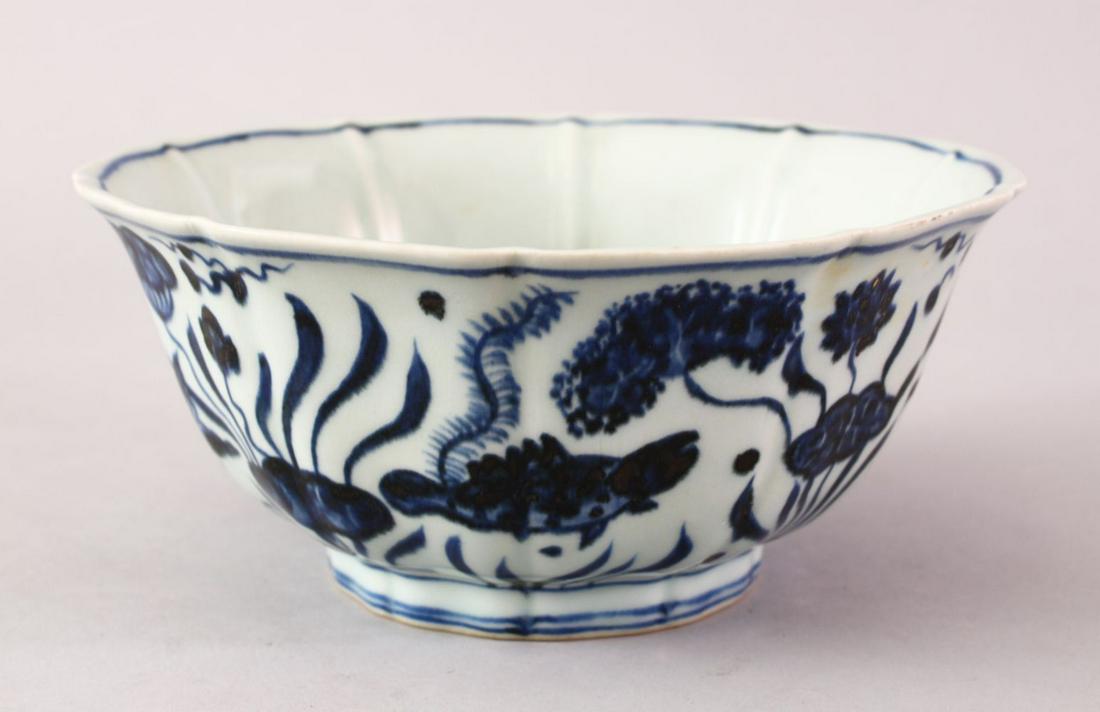A GOOD XUANDE PERIOD CHINESE BLUE & WHITE LOBED: A GOOD XUANDE PERIOD CHINESE BLUE & WHITE LOBED PORCELAIN BOWL, the body of the bowl decorated with scenes of swimming fish amongst lotus and reed, the base with a six character xuande mark and possib