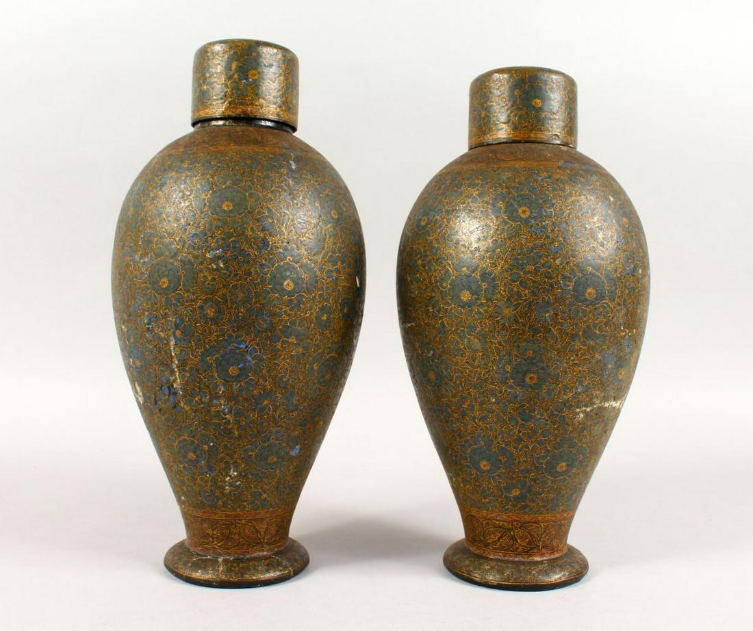 A GOOD PAIR OF 19TH CENTURY OR EARLIER ISLAMIC KASHMIR: A GOOD PAIR OF 19TH CENTURY OR EARLIER ISLAMIC KASHMIR LACQUER DECORATED VASES & COVERS, the body of the vases decorated with scenes of native floral decoration, 31.5cm high.
