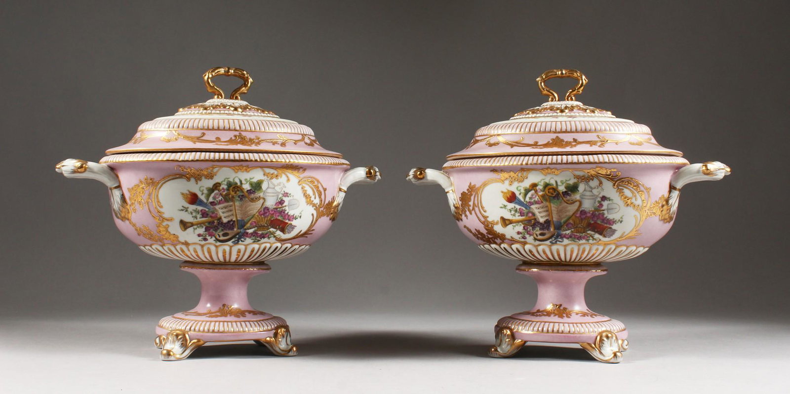 A PAIR OF SEVRES DESIGN PORCELAIN OVAL TUREENS AND: A PAIR OF SEVRES DESIGN PORCELAIN OVAL TUREENS AND COVERS, with reverse panels of musical trophies and flowers. 8.5ins high.