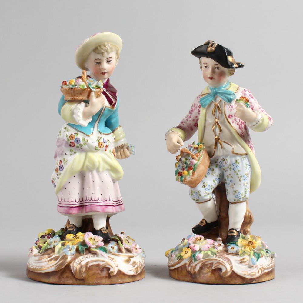 A PAIR OF 19TH CENTURY DERBY FIGURES, a young boy and: A PAIR OF 19TH CENTURY DERBY FIGURES, a young boy and girl, each holding a basket of flowers. 6ins high.