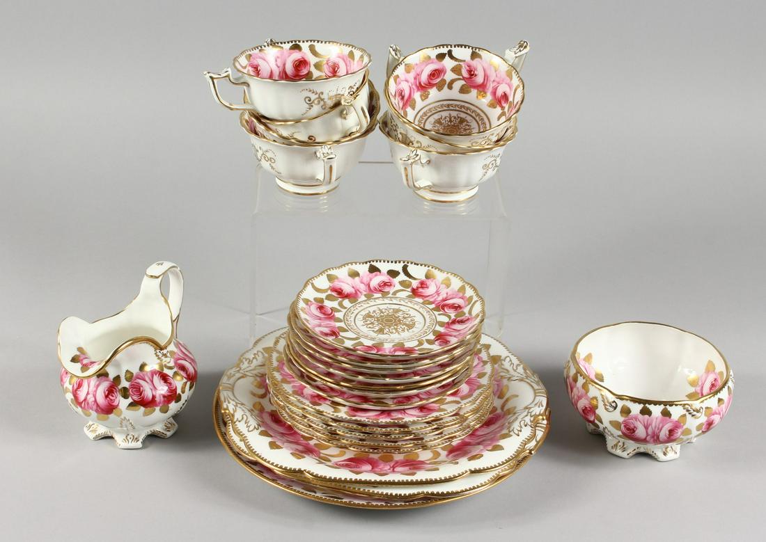 A TEA SET, with gilt decoration painted with roses: A TEA SET, with gilt decoration painted with roses, comprising seven cups, seven saucers, five small plates, two large plates and a similar Davenport plate.