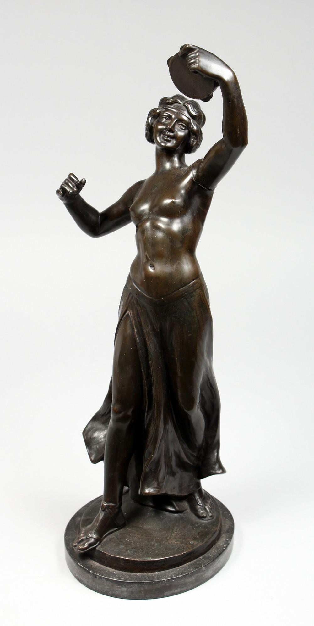 A GOOD EARLY 20TH CENTURY BRONZE FIGURE, modelled as a: A GOOD EARLY 20TH CENTURY BRONZE FIGURE, modelled as a standing female semi-nude, playing a tambourine, on a marble base. 19ins high.