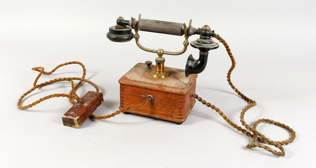 A VINTAGE ERICSSON TELEPHONE, with Bakelite handle,: A VINTAGE ERICSSON TELEPHONE, with Bakelite handle, brass stand and wooden base.