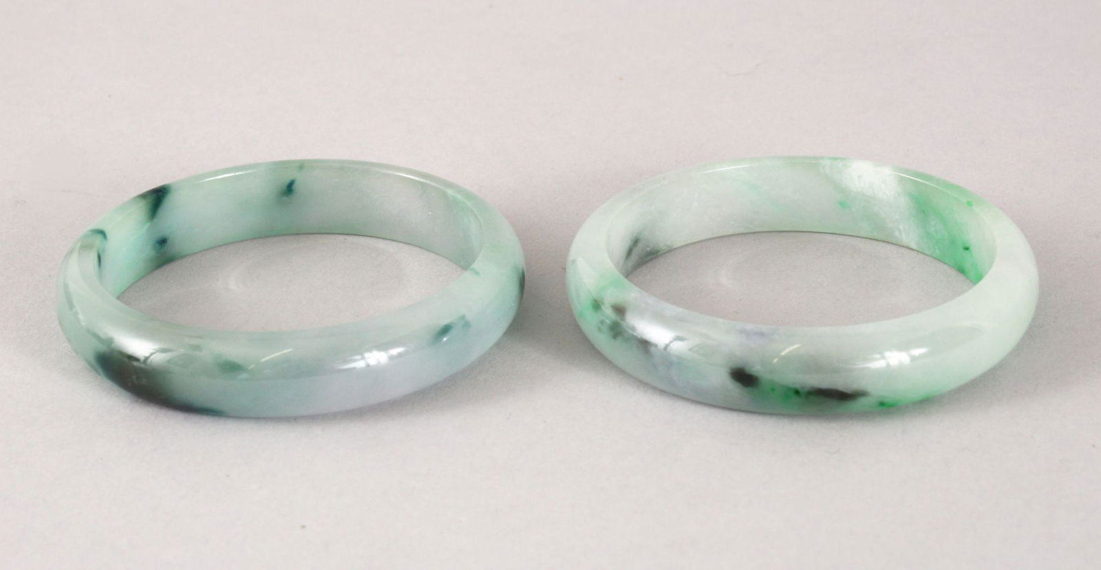 TWO 19TH / 20TH CENTURY CHINESE CARVED JADEITE BANGLES, (1 of 2)