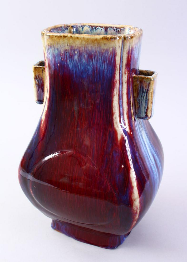 A GOOD CHINESE FLAMBE TWIN HANDLE PORCELAIN HU VASE,: A GOOD CHINESE FLAMBE TWIN HANDLE PORCELAIN HU VASE, with a graduating flambe glaze and twin moulded handles, the base ith an impressed six character mark to base, 30cm